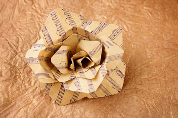 Beautiful rose made of music notes on textured paper closeup