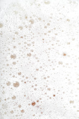 Beer foam as a background. Close up of beer bubbles