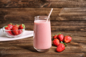 Delicious yogurt smoothie with strawberry  on wooden background
