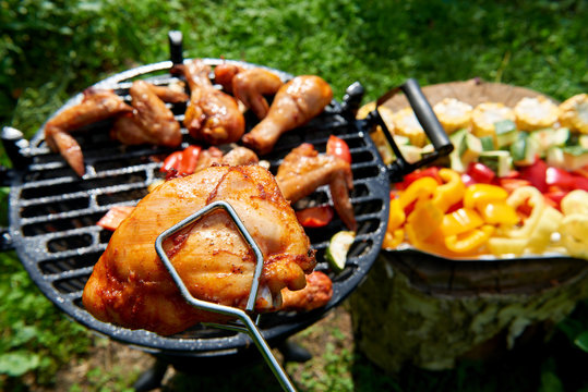 Meat and vegetables during grilling. Assorted types of chicken