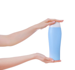 Female hands with bottle of cosmetic product for shower on white background