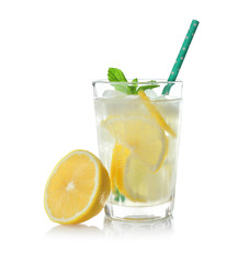 Glass of cold lemon water with ice on white background