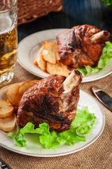 Roasted turkey knuckle with fried potato slices