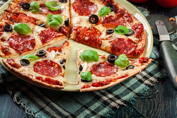 Pizza pepperoni with olives served