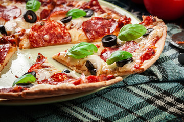 Pizza pepperoni with olives served