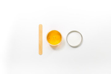 Wax and stick for depilation on white background top view copyspace