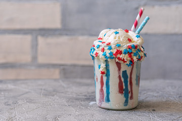 Fototapeta premium Vanilla funfetti milkshake with ice cream. Patriotic drink cocktail