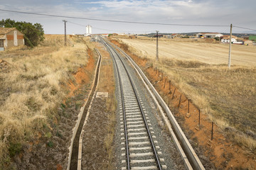 Fototapeta na wymiar train-station at Ferreruela de Huerva and a railroad through the countryside, province of Teruel, Aragon, Spain