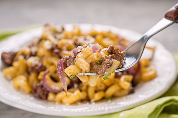 tasty cellentani pasta with meat sauce