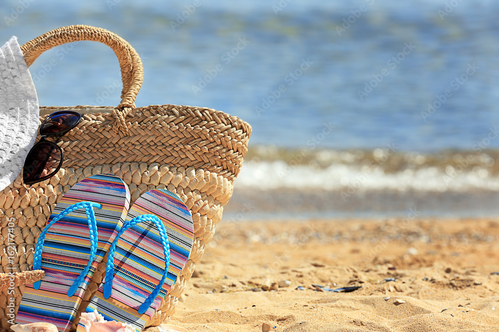 Poster Beach accessories on sand at sea shore. Vacation concept