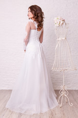 Fototapeta premium Beautiful woman in wedding dress pose in studio