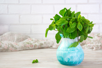 sheaf of fresh mint leaf on rustic background. Copy space