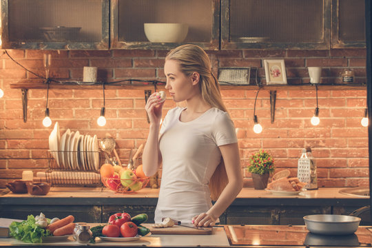 Young woman cooking healthy fresh meal at home
