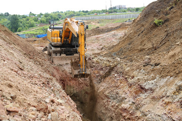 Excavator digging a trench for the pipeline