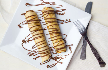 Chocolate pancakes on a white plate