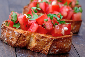 Bruschetta with tomatoes and garlic on table