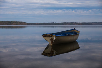 Old blue boat on blue lake water