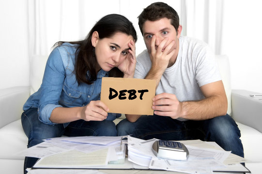 couple worried need help in stress at home couch accounting debt bills bank papers expenses and payments
