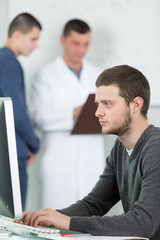 portrait of teenage boy with classmate and teacher