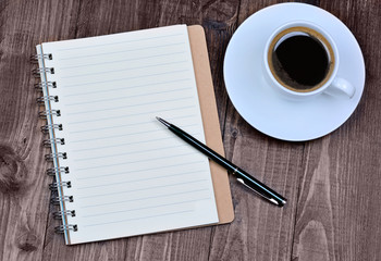 Empty notepad with coffee on table