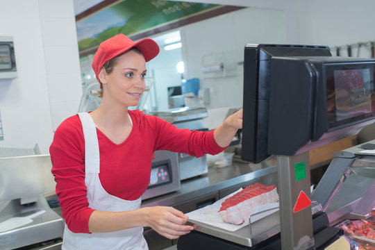 portrait of confident female butcher working