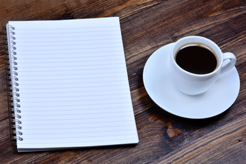 Empty notepad with coffee on table