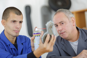 Fototapeta premium lubricating a mechanical piece in vocational college