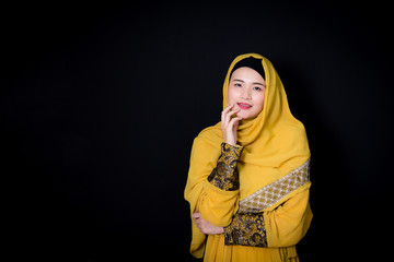 Naklejka premium Portrait of beautiful muslim asian woman over black background with happy muslim woman, Age 20-30 years.