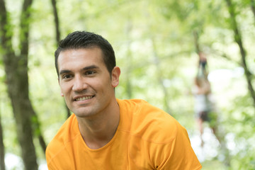 man in high rope course climbing for sport