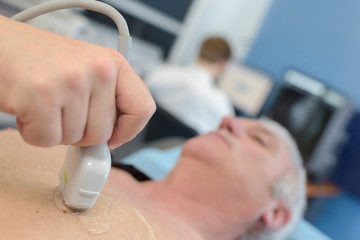 senior man getting ultrasound scan on chest