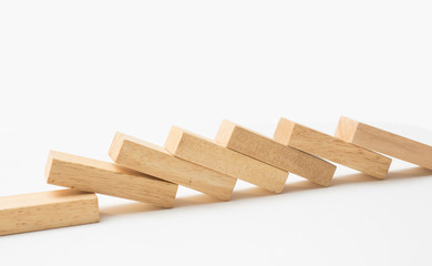 Domino effect, row of wood domino on white background