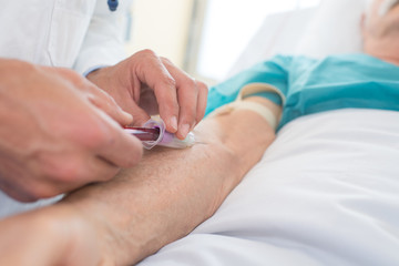 close-up of a male doctor collectng blood from patient