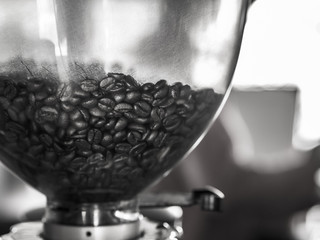 black and white picture of coffee beans in Coffee grinder, In a cafe.