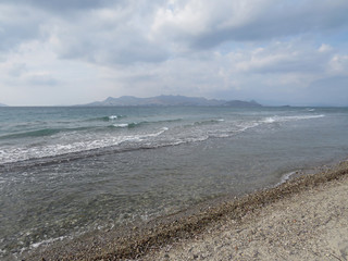 A wild beach with a view of Turkish Bodrum. Kos Island, Greece
