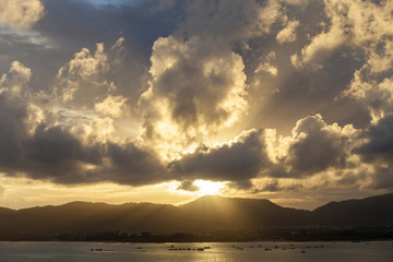 Sunset with sky ,clouds over mountain and andaman sea at phuket thailand