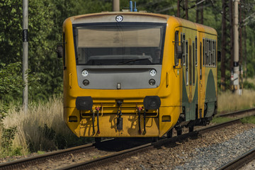 Fototapeta premium Yellow and orange train near Kostov station