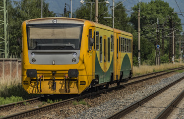 Fototapeta premium Yellow and orange train near Kostov station