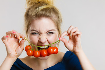 Woman holding fresh cherry tomatoes