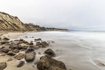 Fototapeta na wymiar Dume Cove beach with motion blur water in Malibu, California.