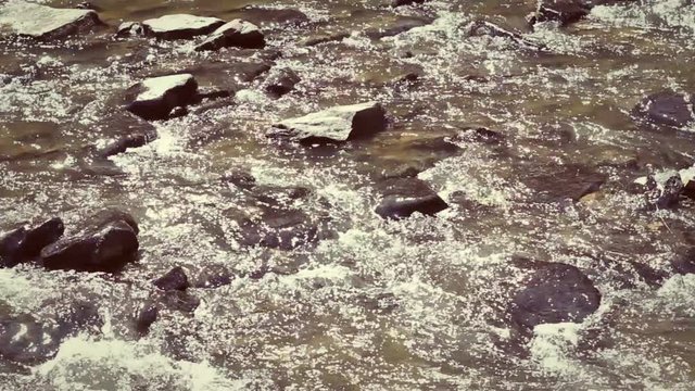 Shallow Creek water flowing through rocky terrain during daylight