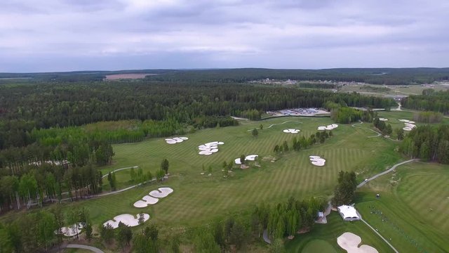 Top view green golf course outdoor green grass field. Aerial view from flying drone.