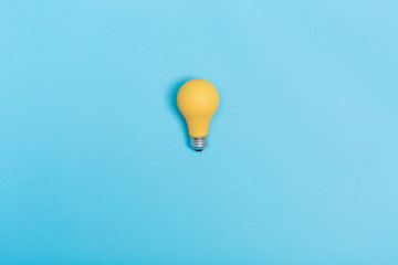 Colored light bulb on vivid colored background