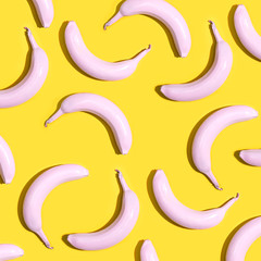 Series of painted pink bananas on a yellow background