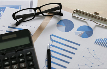 Checking financial reports paperwork and Business  Teamwork on Preparing report Blue graphs  glasses