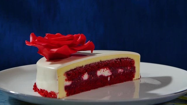 Cake and biscuits in the shape of a heart in the context of. The red rose made of cream on the cake