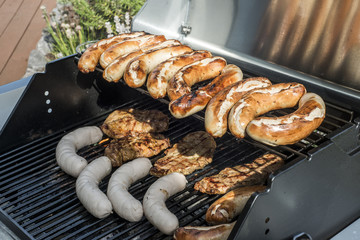 Barbecue grill bbq on propane gas grill steaks bratwurst sausages meat meal