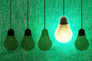 Abstract paper Idea concept in search of great idea. LED bulb and simple light bulbs.Green background.