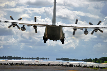 Military transport aircraft landing on runway