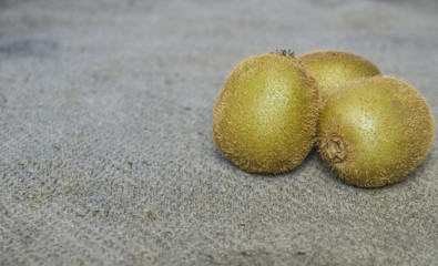 Ripe whole kiwi fruit and half kiwi fruit isolated put on brown sack