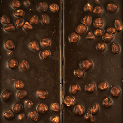 Chocolate background. chocolate with hazelnuts close-up.